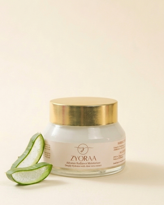 Zyora cream jar with gold lid and aloe vera slices on a beige background