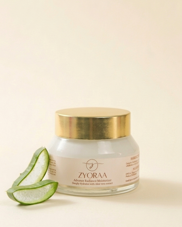 Zyora cream jar with gold lid and aloe vera slices on a beige background